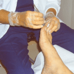 Certified foot care nurse working on patient